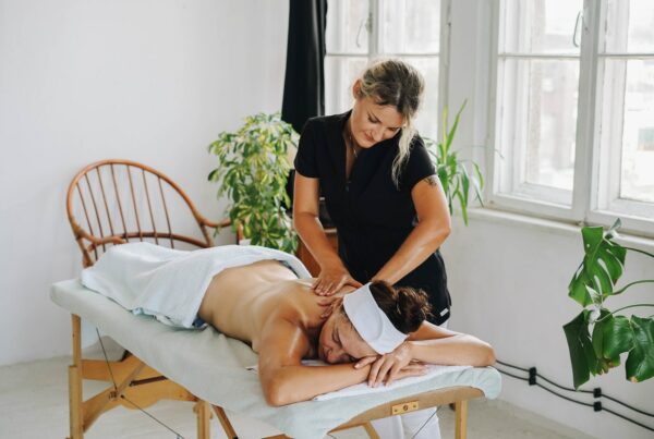 Mobile massage best insurance blog_ woman receiving in home massage by mobile massage therapist