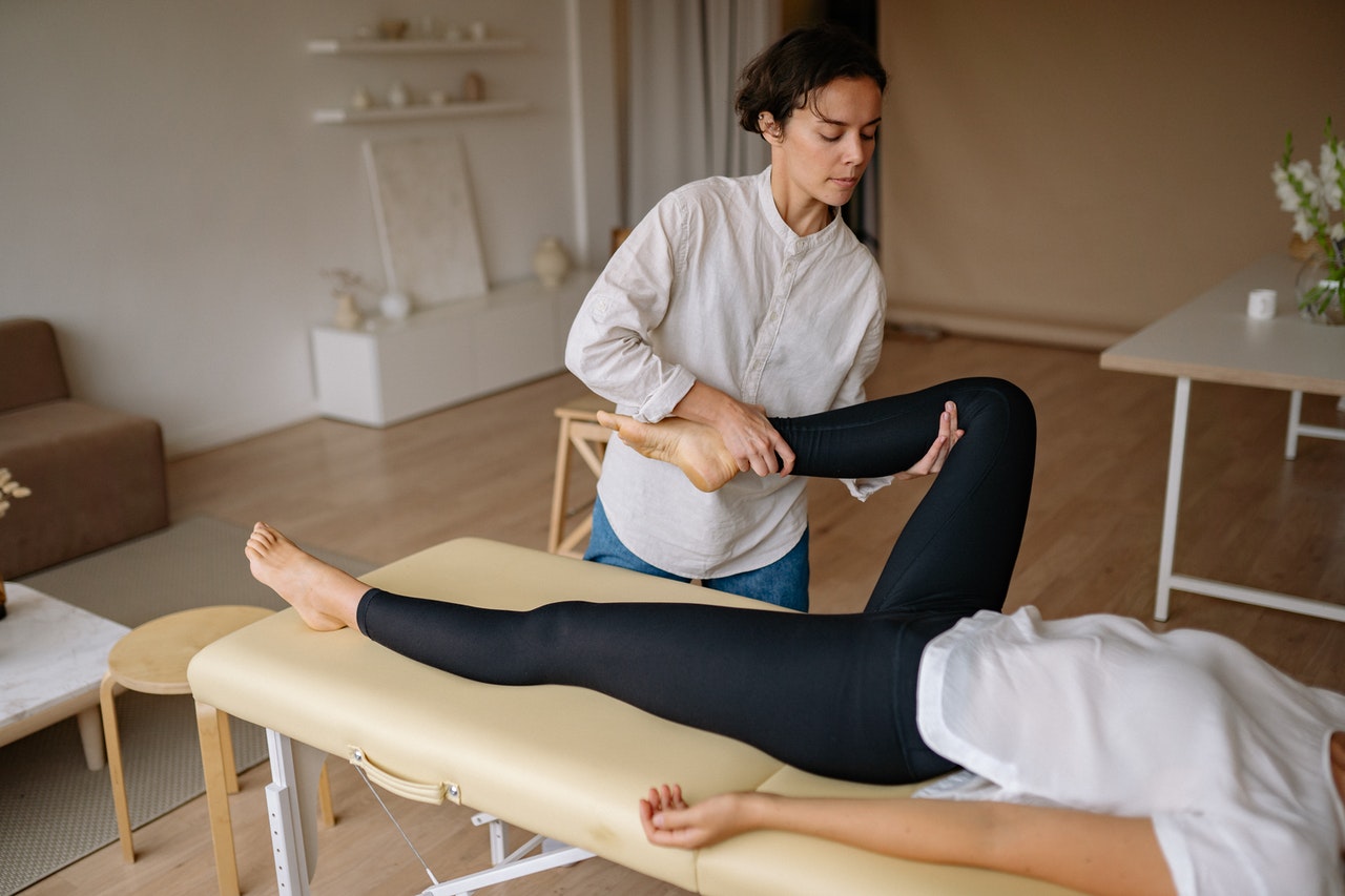 Sports massage - woman stretching