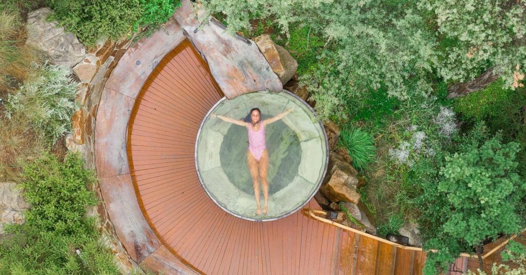 birds eye view of woman laying in a spa in nature