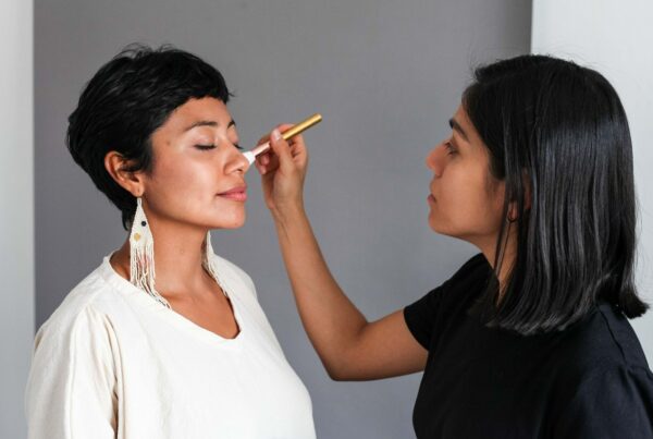 Makeup artist applying makeup to her female client